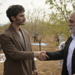 Two men speak outdoors in a still from Halef: Köklerin Çağrısı Episode 13.
